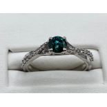 18ct White Gold Fancy Ring with a 0.40ct coloured diamond centre stone and 0.15cts of smaller
