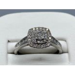Ladies 18ct white gold diamond cluster ring. Featuring round brilliant cut diamond set in centre