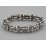 Ladies 14ct white gold and diamond set ornate bracelet with safety catch 20g