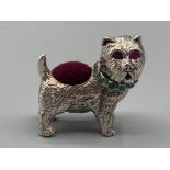 A silver scotty dog pincushion with ruby eyes and emerald collar, 17.4g