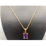 Ladies 9ct yellow gold purple stone set pendant and 9ct yellow gold diamond cut belcher chain (24.