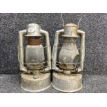 A large pair of hurricane oil lamps