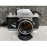 A Nikon F 35mm SLK film camera, no 6936228 with camera lens