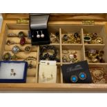 Wooden jewellery box containing mainly costume jewellery clip on earrings, also includes a silver