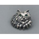 A silver cat brooch with emerald eyes 5.46g gross