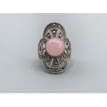 A silver and marcasite ring with rose quartz panel 6.81g gross