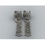 A pair of silver and marcasite designer style leopard head earrings with ruby eyes 13.10g gross