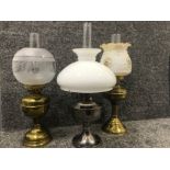 2 brass oil lamps together with a white metal oil lamp all complete with shades