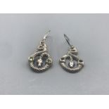 A pair of silver and peridot snake earrings 6g gross