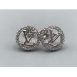 A pair of silver and cz Louis Vuitton style stud earrings