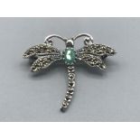 A silver and marcasite dragon fly brooch with emerald cabochon