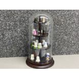 Mixture of thimbles in a glass dome display case, 17 in total