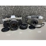 Olympus-pen camera with F=30mm lens together with Olympus OM10 camera with Olympus Zuiko auto-s 50mm