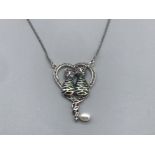 A silver marcasite and enamel heart shaped pendant necklace in the form of cats 9.43g gross