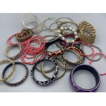 Tin containing a large quantity of miscellaneous costume jewellery bangles & bracelets