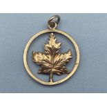 10k yellow gold “Canada Leaf” circular shaped pendant, 1.6