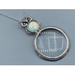 A silver magnifying glass pendant necklace with Opal panel of owl form, 14.6g gross