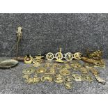 Box containing a collection of vintage brass buckles including horses cats a brass candlestick etc