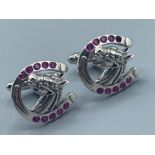 A pair of silver & Ruby horseshoe shaped earrings, 11g gross