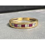 Ladies 18ct gold Ruby and diamond band ring. 2g size L1/2