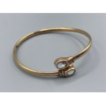 9ct gold diamond and blue stone set bangle, 7.4g