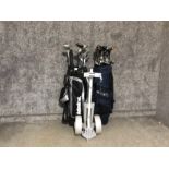 2 golf bags containing various different clubs together with golf trolley