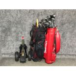 2 golf bags with variety of different clubs together with golf trolley