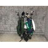 2 golf bags containing various different clubs together with golf trolley