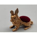 A brass rabbit pincushion