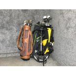 3 golf bags containing a variety of different clubs together with a golf trolley