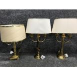 A pair of metal and brass table lamps together with brass table lamp