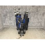2 golf bags containing various different clubs together with a golf trolley