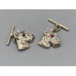 A pair of silver dog cufflinks with ruby eyes 4.0g