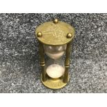 Vintage brass hourglass sand timer depicting time