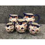 5 vintage ironstone jugs with blue and white floral design variety of sizes