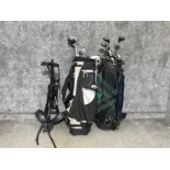 2 golf bags containing various different clubs together with golf trolley