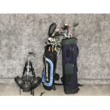 2 golf bags with variety of different clubs together with golf trolley