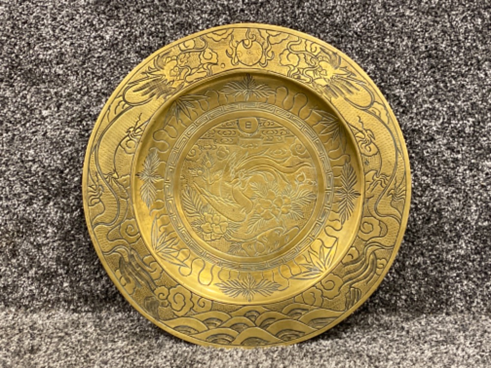 Very heavy chinese brass dish decorated with drangons birds, the rising sun and sea. Seal to the