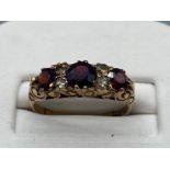 9ct gold ring with garnet and cz, size O 2.5g