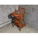 An antique child's red painted wooden high chair