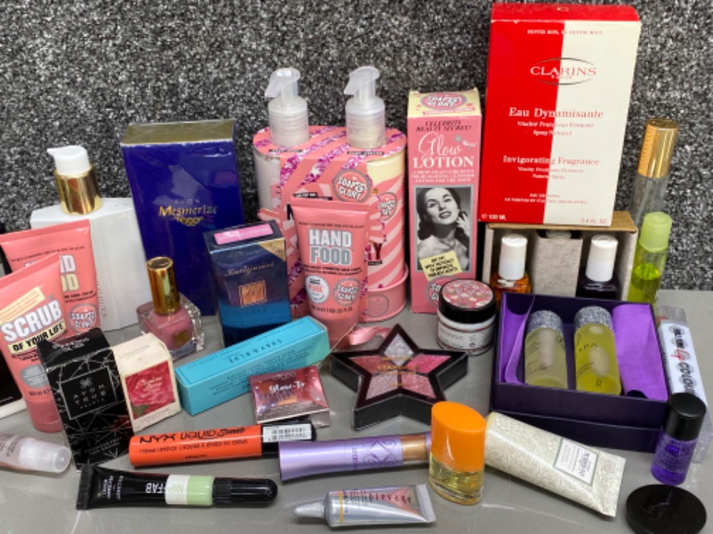 Box containing a various amount of woman’s beauty products, including soaps, perfume & make-up