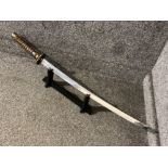 Ornamental Japanese katana (samurai sword) on wooden display stand