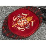 Old smoking hat in red & black with needlework crest & flags to the top