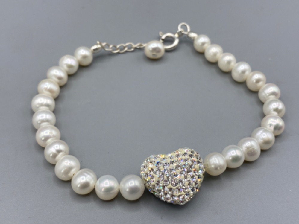 A silver freshwater pearl bracelet with heart shaped cabochon set with cz