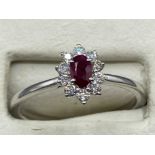 A platinum set ruby and diamond ring of 60 points, 3.2g size N1/2