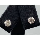 A pair of 14ct white gold diamond stud of 1.11 cts, 0.8g