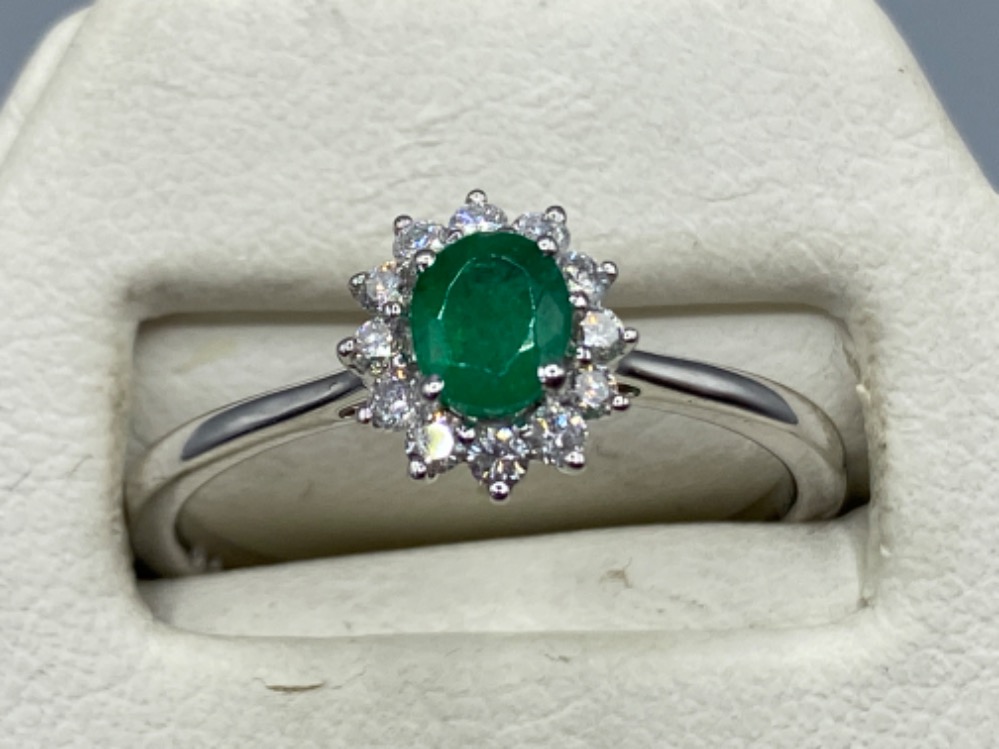 An 18ct white gold emerald and diamond cluster ring of 60 points, 3.2g size O