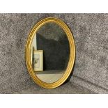 Gilt framed oval shaped wall mirror 86x61cm