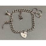 Hallmarked Birmingham silver 1969 charm bracelet with padlock & 4 charms, 29.1g