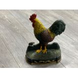 Cast metal rooster door stop